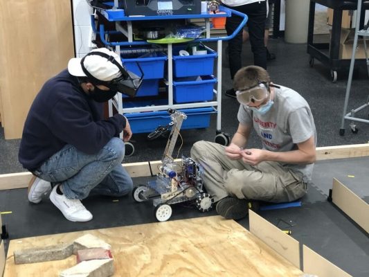 Eduardo Zarinana, left, and Ben Otterbacher working on their robot, Daily Herald