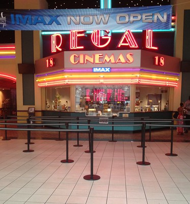 An image of a ticket booth at a Regal movie theater.