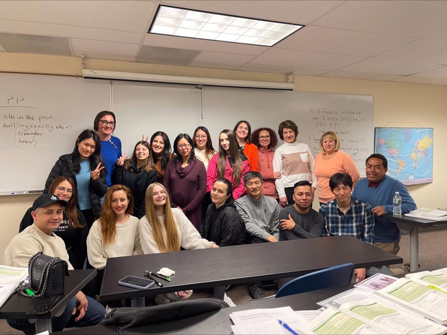 ESL students gather for a group phot with Instructor Selena Woods in their Southlake classroom.