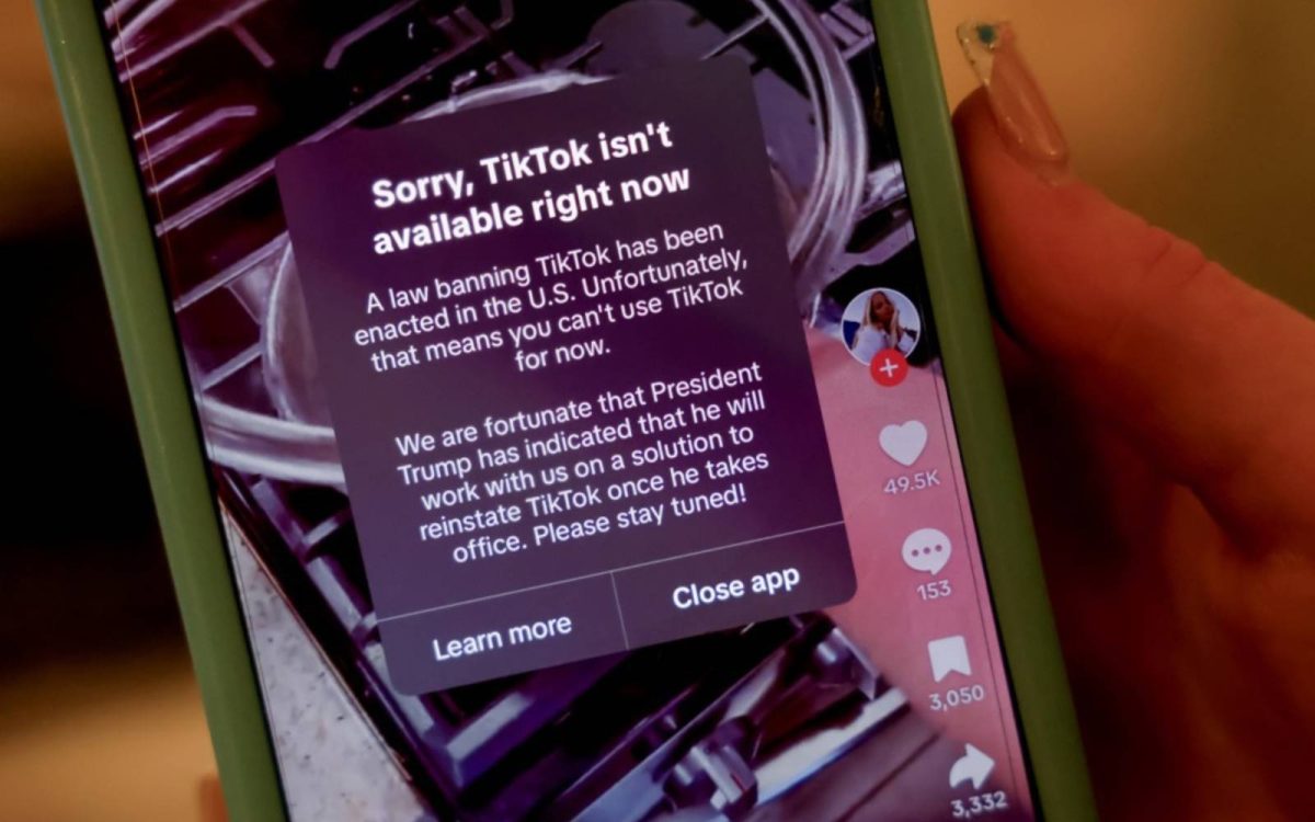  A person holds an iPhone with a message on their TikTok 